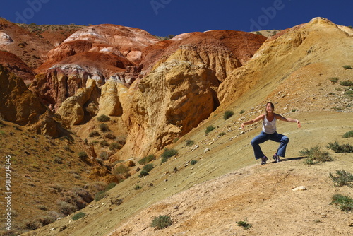 Tourists pose against the background of Martian landscapes – a red deserted area with canyons. 