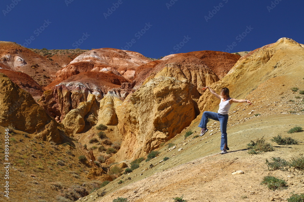 Tourists pose against the background of Martian landscapes – a red deserted area with canyons.
Tourists pose against the background of Martian landscapes – a red deserted area with canyons.