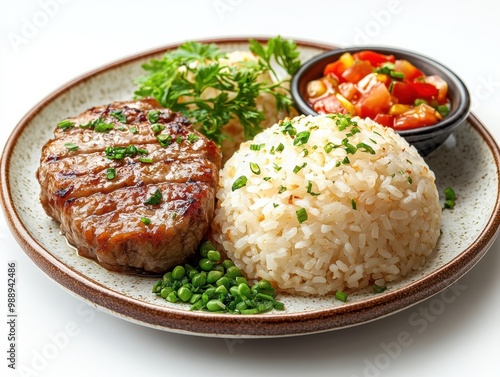 Delicious grilled steak with rice and fresh vegetables on a plate.