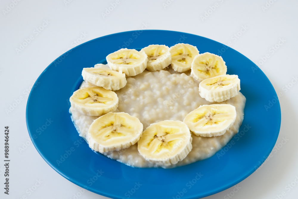 Breakfast porridge, bananas, and slice banana. food healthy diet concept. a plate of porridge with slices of bananas on it in blue and white on a . a plate of porridge with slices of bananas, greens,. Breakfast porridge, bananas, and slice banana. food healthy diet concept. a plate of porridge with slices of bananas on it in blue and white on a . a plate of porridge with slices of bananas, greens,.