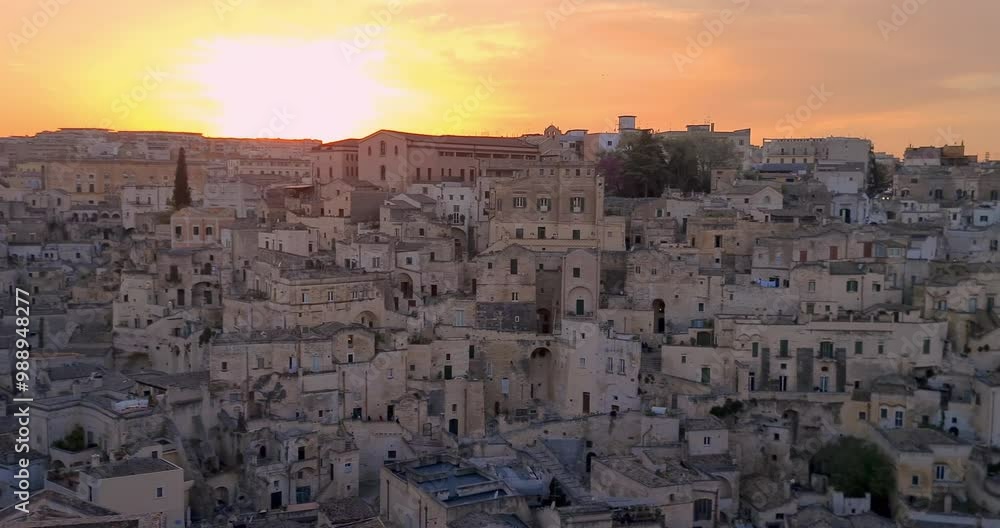 Matera holiday, summer, panorama of historic Matera stone with bell tower under sunset colorful sky, European Capital of Culture 2019, concept of cultural holidays Matera holiday, summer, panorama of historic Matera stone with bell tower under sunset colorful sky, European Capital of Culture 2019, concept of cultural holidays