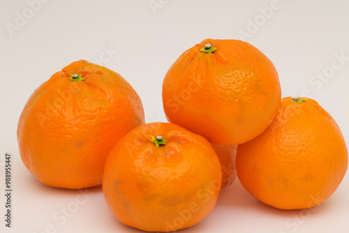 Tangerines and oranges in gray with a ripe fruit. new year's orange concept. a colorful of tangerines and other fruits of the new year. a tangerine on a gray with fruits of the new lifestyle year.