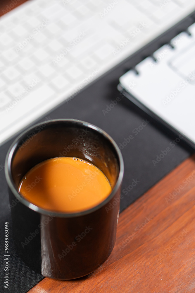 Black Mug with Coffee on Office Desk Setup Black Mug with Coffee on Office Desk Setup