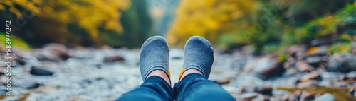 A person relaxing with their feet in a stream, enjoying a quiet Sunday in nature, Sunday nature escape, peaceful life photo