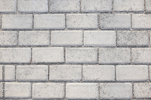 A close-up of a gray brick pavement, perfect for backgrounds or textures. ideal for adding a touch of urban realism to designs.