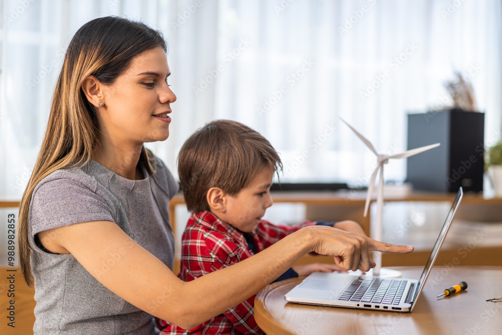 Mother helping young son with online learning on a laptop, homeschooling and education concept, woman and child spending quality time together, modern technology, digital education, family interaction Mother helping young son with online learning on a laptop, homeschooling and education concept, woman and child spending quality time together, modern technology, digital education, family interaction