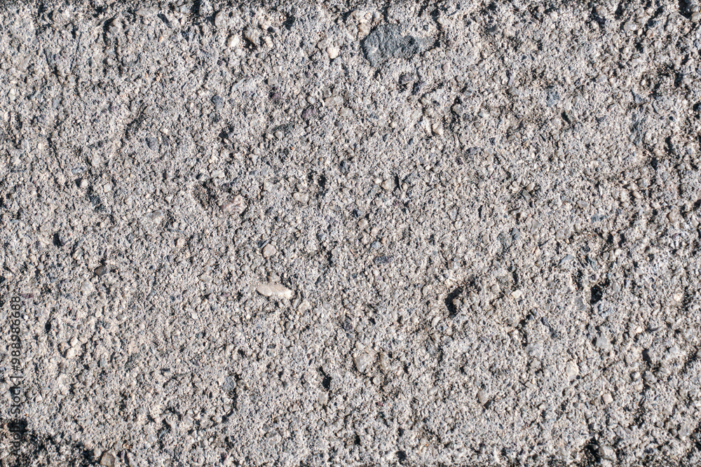 This image is a close-up texture of rough concrete with gravel. The image can be used as a background for a variety of projects, from website design to print media. This image is a close-up texture of rough concrete with gravel. The image can be used as a background for a variety of projects, from website design to print media.