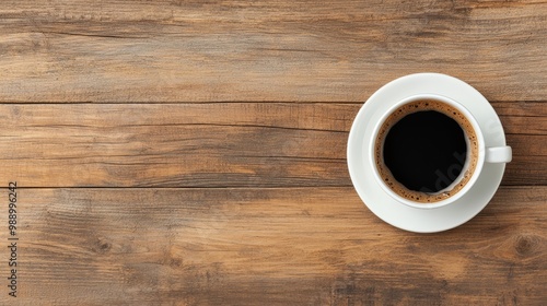 Black coffee in a white cup on a rustic wooden table.