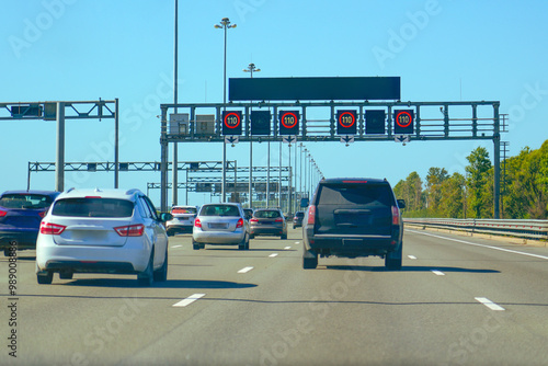 Dense stream of cars on a city road back view on the bypass expressway.