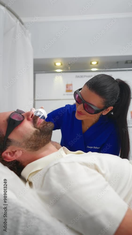 Woman Cosmetologist Performs Beard Edging Procedure with Laser Hair Removal at Beauty Salon. Concept of Body Care and Health. Vertical Video. Slow motion. Woman Cosmetologist Performs Beard Edging Procedure with Laser Hair Removal at Beauty Salon. Concept of Body Care and Health. Vertical Video. Slow motion.