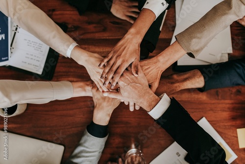 Business people stacking their hands together