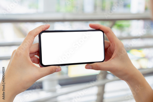 Hand holding smartphone mockup of blank screen, Take your screen to put on advertising.