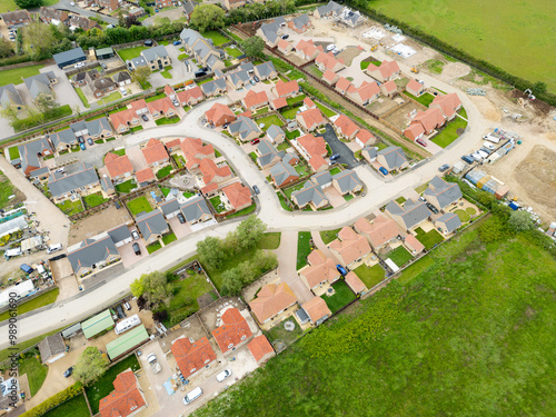 Aerial view of a new retirement bungalow home development seen on a sprawling east Anglian village in rural Cambridgeshire, UK. Seen adjacent to recently completed homes on the left. photo