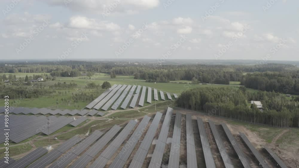 Aerial view of a large solar farm in the countryside, featuring rows of panels stretching across the landscape. Captured in high-quality s-log and 4K. Aerial view of a large solar farm in the countryside, featuring rows of panels stretching across the landscape. Captured in high-quality s-log and 4K.
