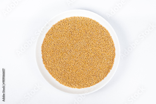 Mustard seeds on white background, natural organic seasoning, top view.