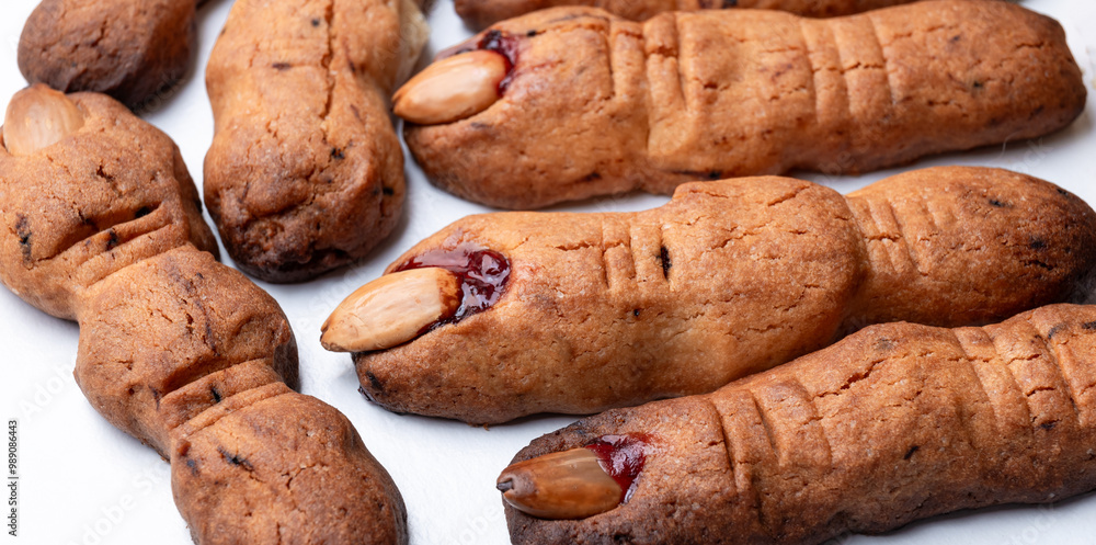 Spooky witch finger cookies for Halloween, a creative and eerie treat with almond nails. Spooky witch finger cookies for Halloween, a creative and eerie treat with almond nails.