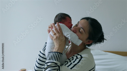 Mother holding and comforting her newborn baby close, both sharing a tender moment filled with love and connection, emphasizing the warmth, care, and bonding between mother and child