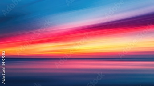 A dynamic horizon with a blurred sunset, showcasing vibrant tones of red, pink, and gold fading into a soft blue sky