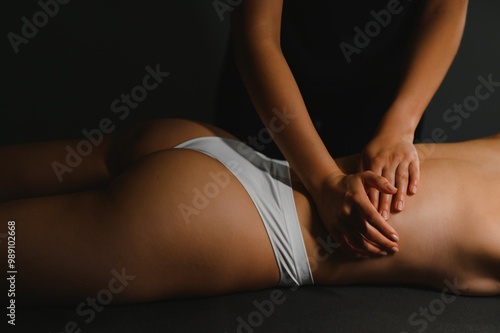 Masseur doing massage on woman back in the spa salon