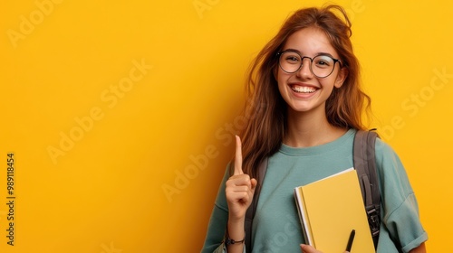 A smiling student, with notebooks, glasses, and a backpack, enthusiastically points to a blank space, ready to highlight something important 