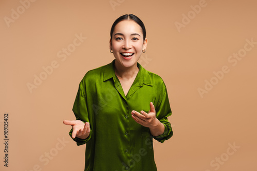 Photography Positive, happy Asian woman wearing green shirt smiling, blogger recording video
