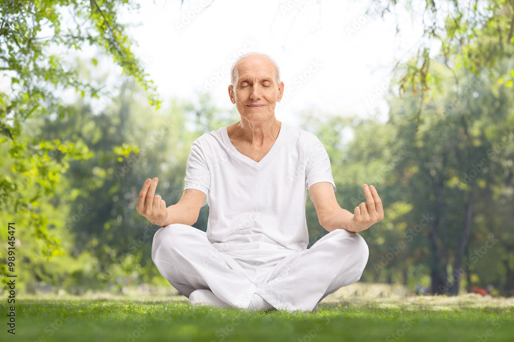 Fototapeta premium Elderly man in white clothes meditating