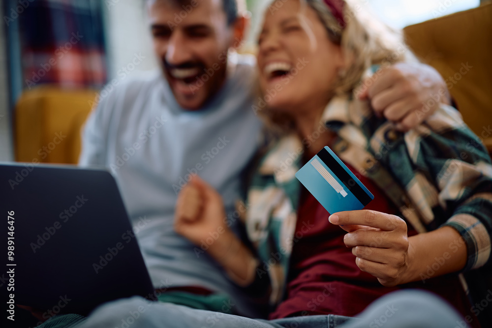 Close up of couple using laptop and credit card for online shopping.