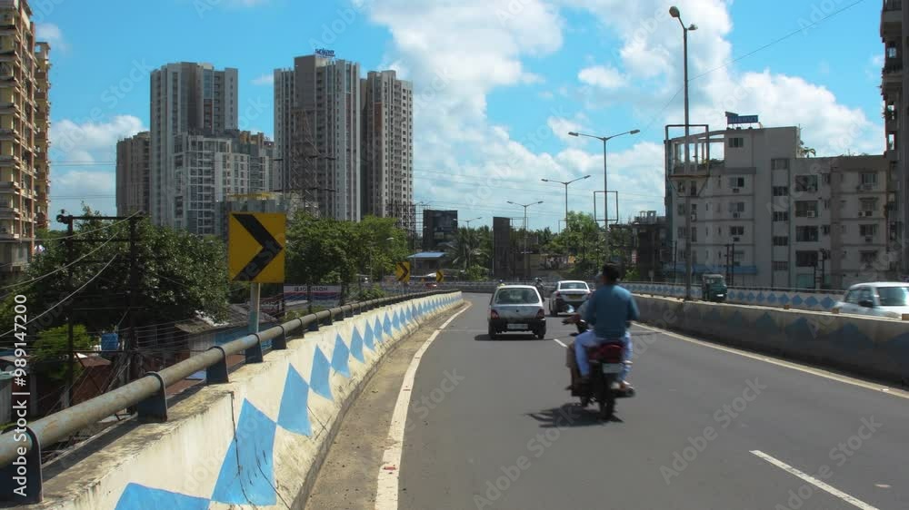 Evening Traffic on Urban Road in Kolkata with Blue Sky and Clouds Evening Traffic on Urban Road in Kolkata with Blue Sky and Clouds