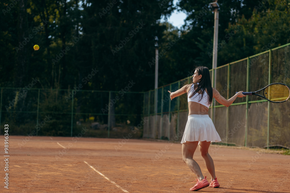 Young woman playing tennis outdoor at summer Young woman playing tennis outdoor at summer