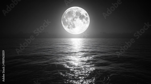 A serene full moon reflecting on calm ocean waters at night.