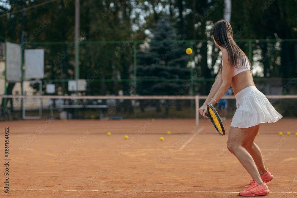 Young woman playing tennis outdoor at summer Young woman playing tennis outdoor at summer