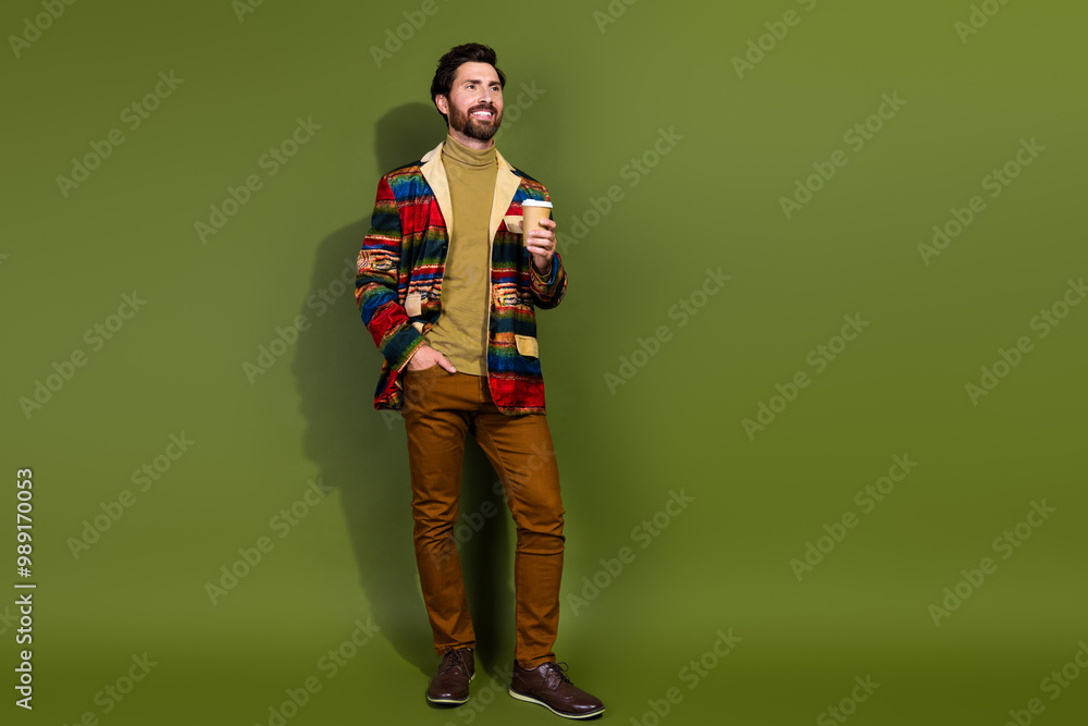 Fototapeta premium Photo of nice positive man dressed stylish clothes drink coffee empty space isolated on khaki color background