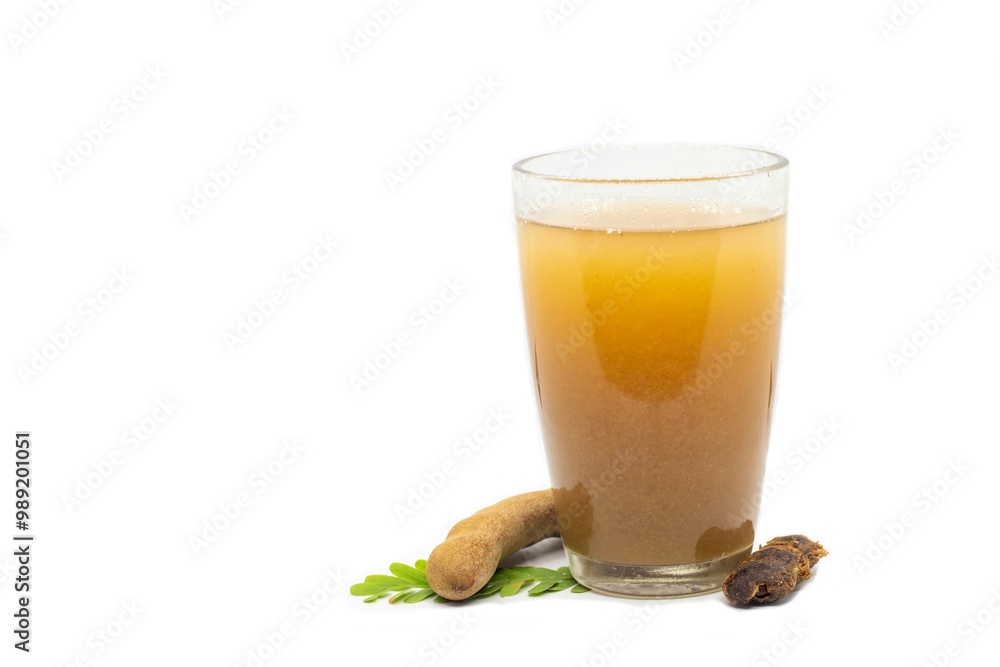 Ripe Tamarind or Imli Fruit Sharbat Water or Juice in a Glass with Leaves Isolated on White Background with Copy Space Ripe Tamarind or Imli Fruit Sharbat Water or Juice in a Glass with Leaves Isolated on White Background with Copy Space
