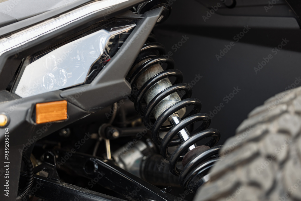 Off road car suspension spring. Close up photo with the interior part of a wheel and steering system of an offroad car.
