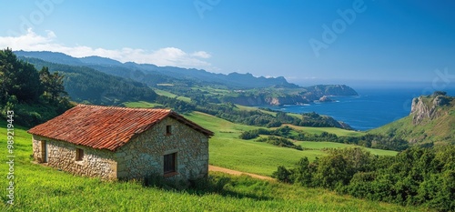 Wallpaper Mural Stone cottage on a grassy hillside with a view of the ocean and mountains. Torontodigital.ca