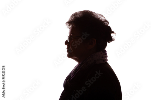 Dark silhouette of an elderly woman, pensioner in glasses - isolate