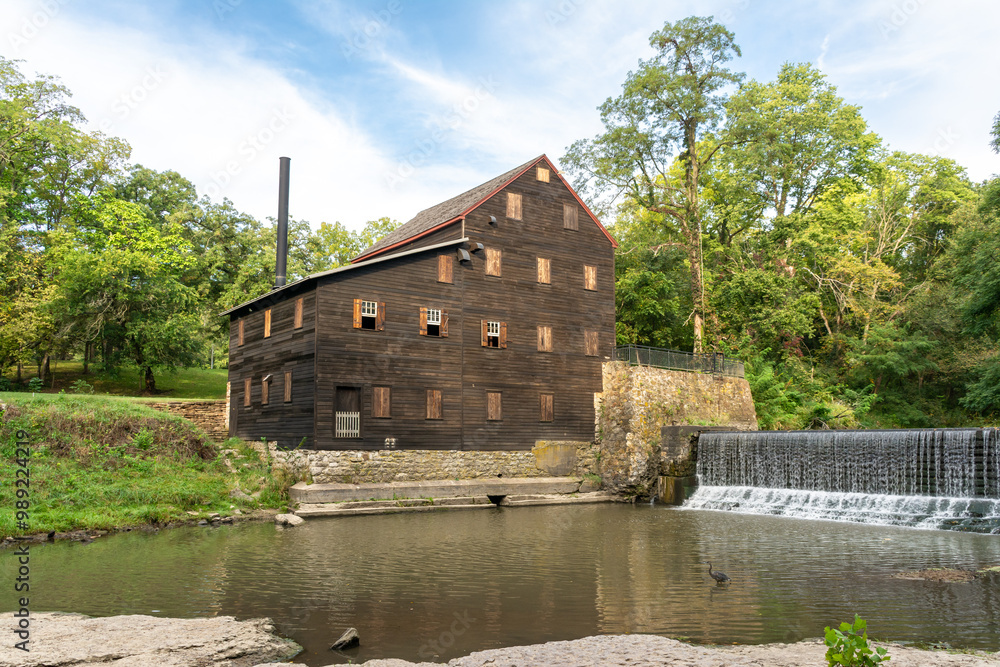 Pine Creek Grist Mill, built in 1848, on a sunny summer morning at Wildcat Den State Park. Muscatine, Iowa, USA. Pine Creek Grist Mill, built in 1848, on a sunny summer morning at Wildcat Den State Park. Muscatine, Iowa, USA.