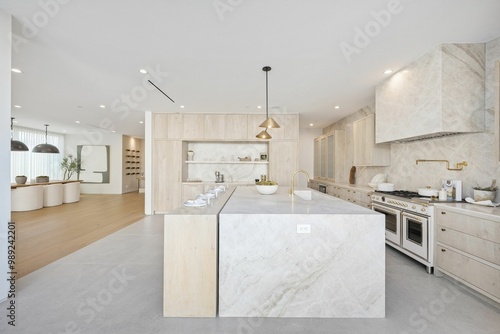 Modern and spacious kitchen with marble island and high-end appliances.