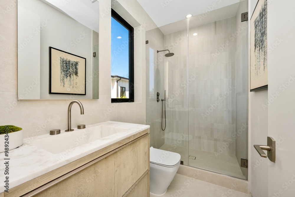Modern bathroom with glass shower and marble countertop Modern bathroom with glass shower and marble countertop