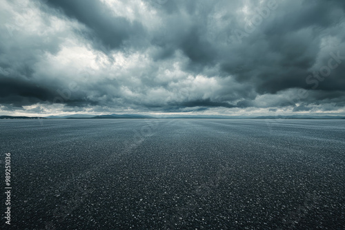 Empty asphalt road covered with rain drops under dramatic sky photo