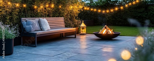 Patio with a cozy bench, a small fire pit, and a string of fairy lights