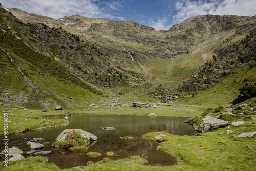 Natural park of valley Comapedrosa at summer with rivers and waterfalls, snow in the mountains, Andorra photo