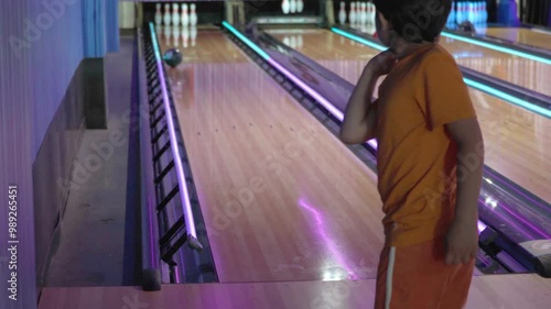 Elementary age boy learning to throw a bowling ball photo