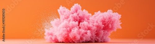 A vibrant pink cloud against an orange background, showcasing creativity and artistic flair in digital design.