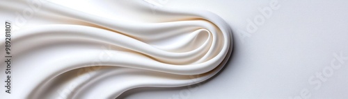 Elegant fabric draping gracefully, showcasing smooth curves and soft textures in a minimalist setting, ideal for design inspirations.