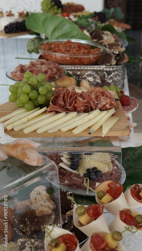 a beautiful table of cold cuts and cheeses at an elegant party