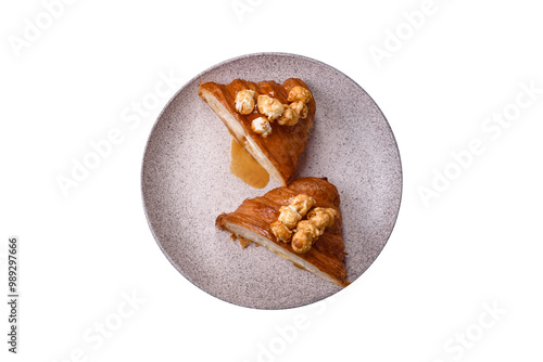 Sweet crispy croissant with salted caramel and glazed popcorn photo