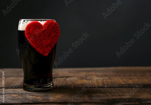 Dark Beer with Red Heart Decoration on Wooden Table photo