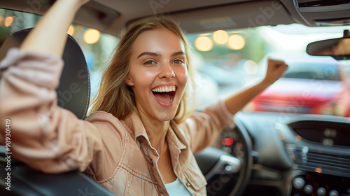 Happy young woman celebrates inside car after achieving driving success. Bought a new car