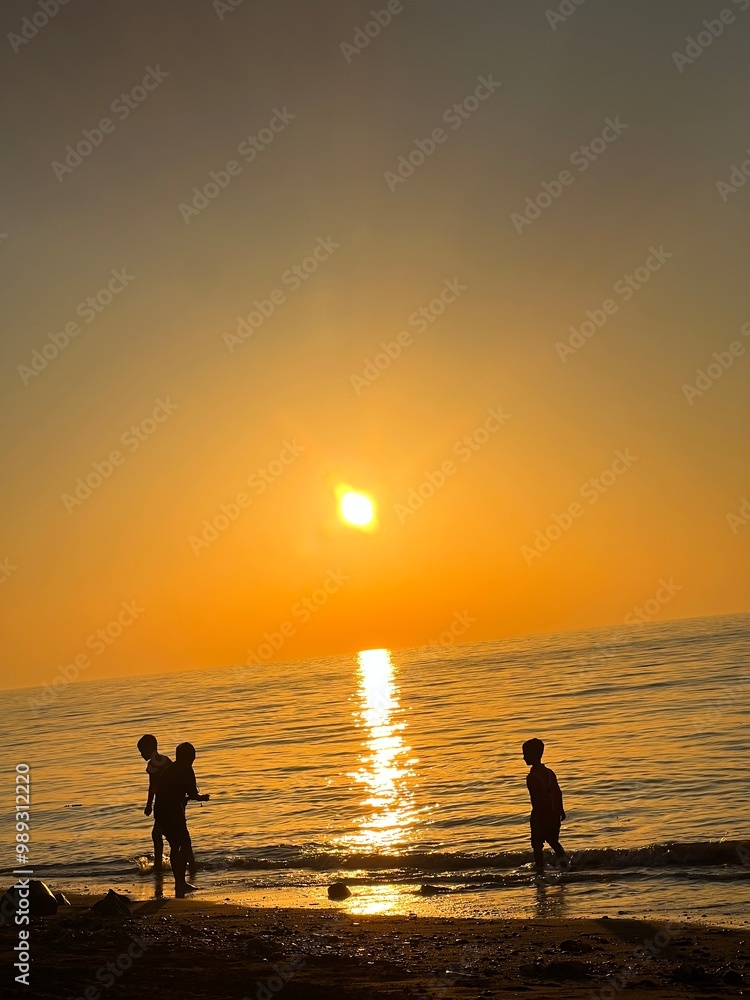 Fototapeta premium A Great View the Sunset beach and Children Are Playing Joyfully
